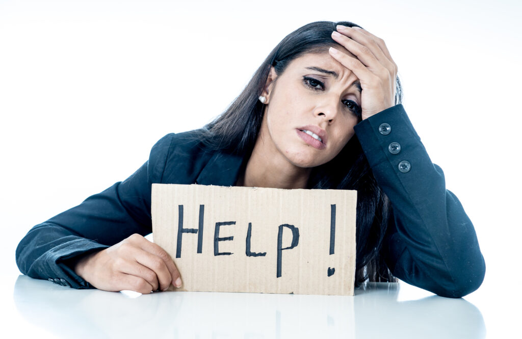miserable working woman with "help" sign